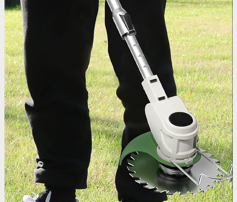 Handheld lawn mower cutting grass in a backyard