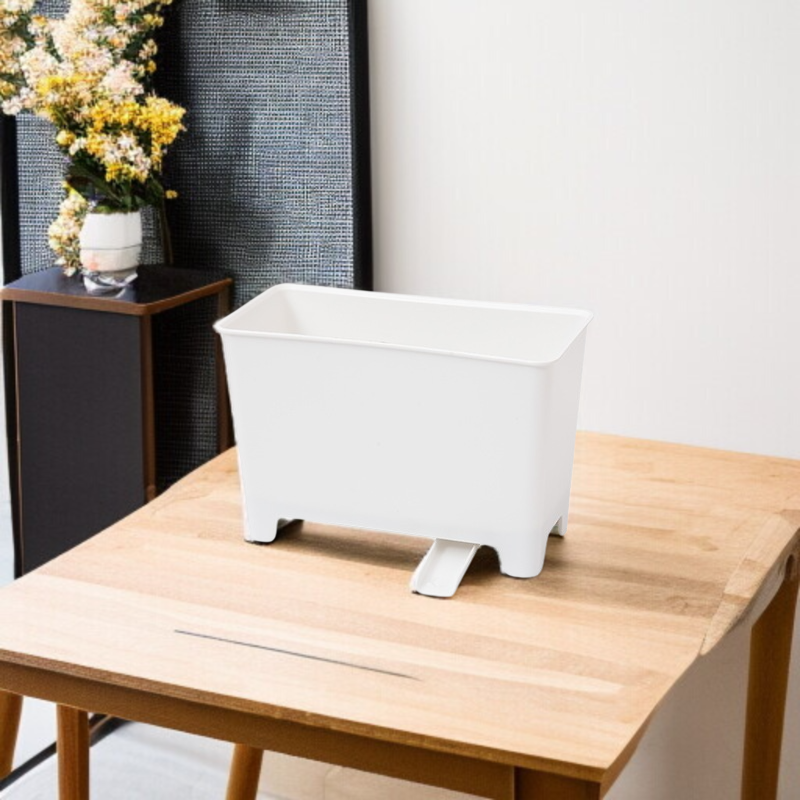 Kuchyňský odpadkový koš vedle dřezu na odkapávající kuchyňský odpad