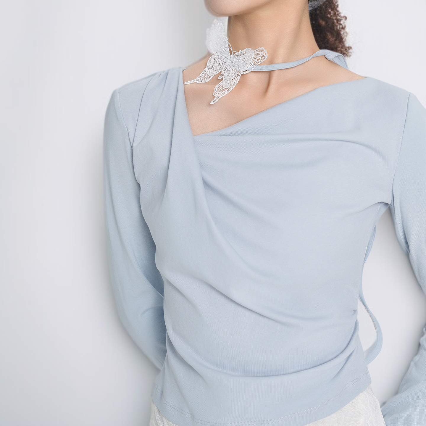 フェイクツーピース風の不規則な長袖トップス