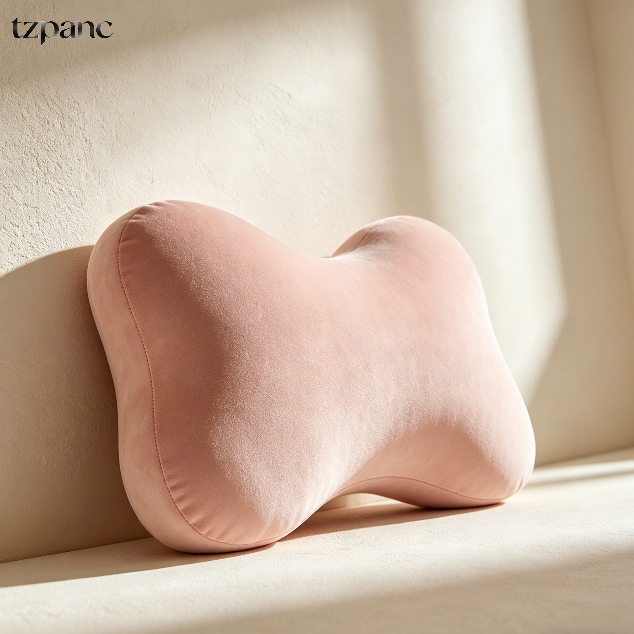 Bone-shaped pillow on bed for back pain relief