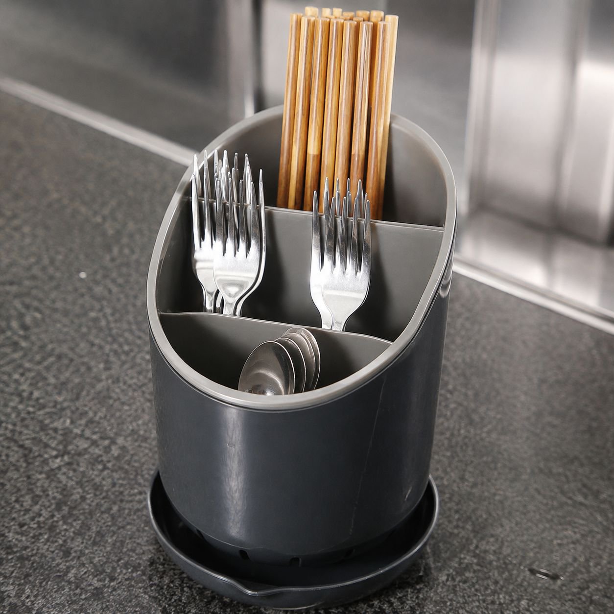 Close-up of multi-layer utensil organizer showing drainage holes