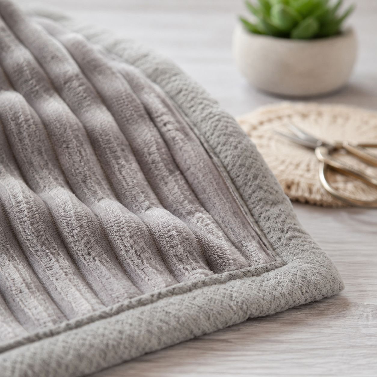 Ultra-soft office blanket folded neatly on desk