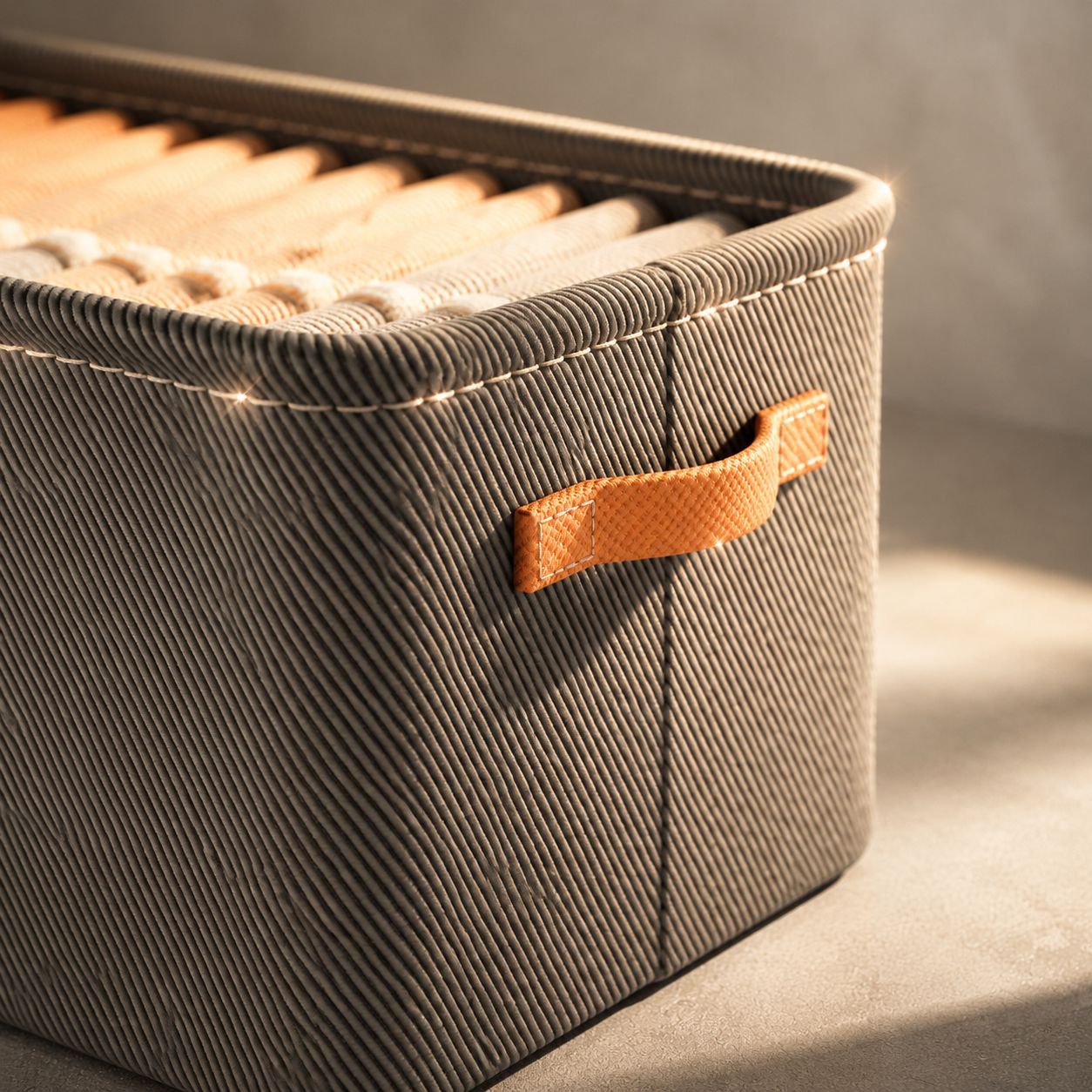 Sturdy fabric bins neatly storing trousers in closet