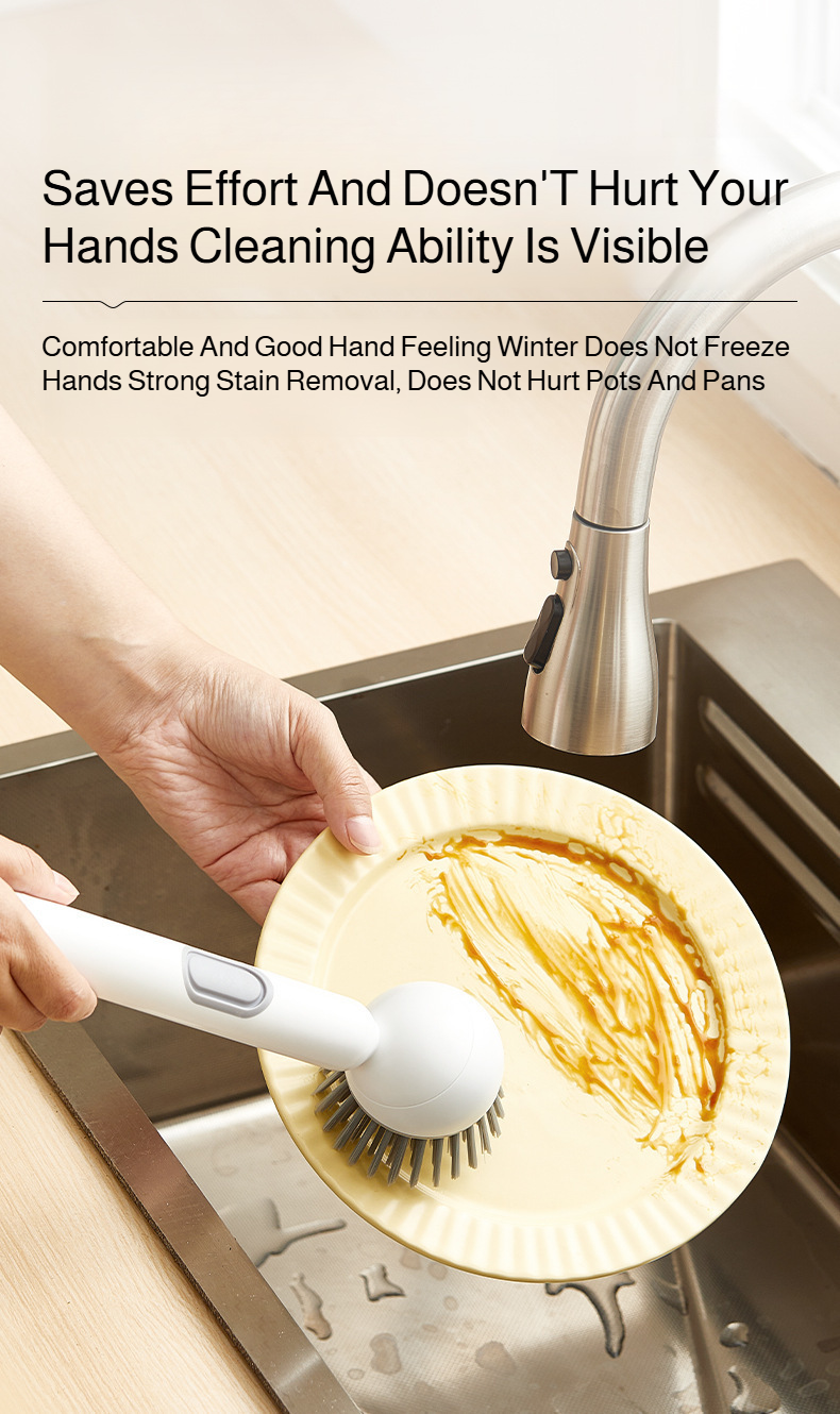 Extended handle brush scrubbing a cooking pot