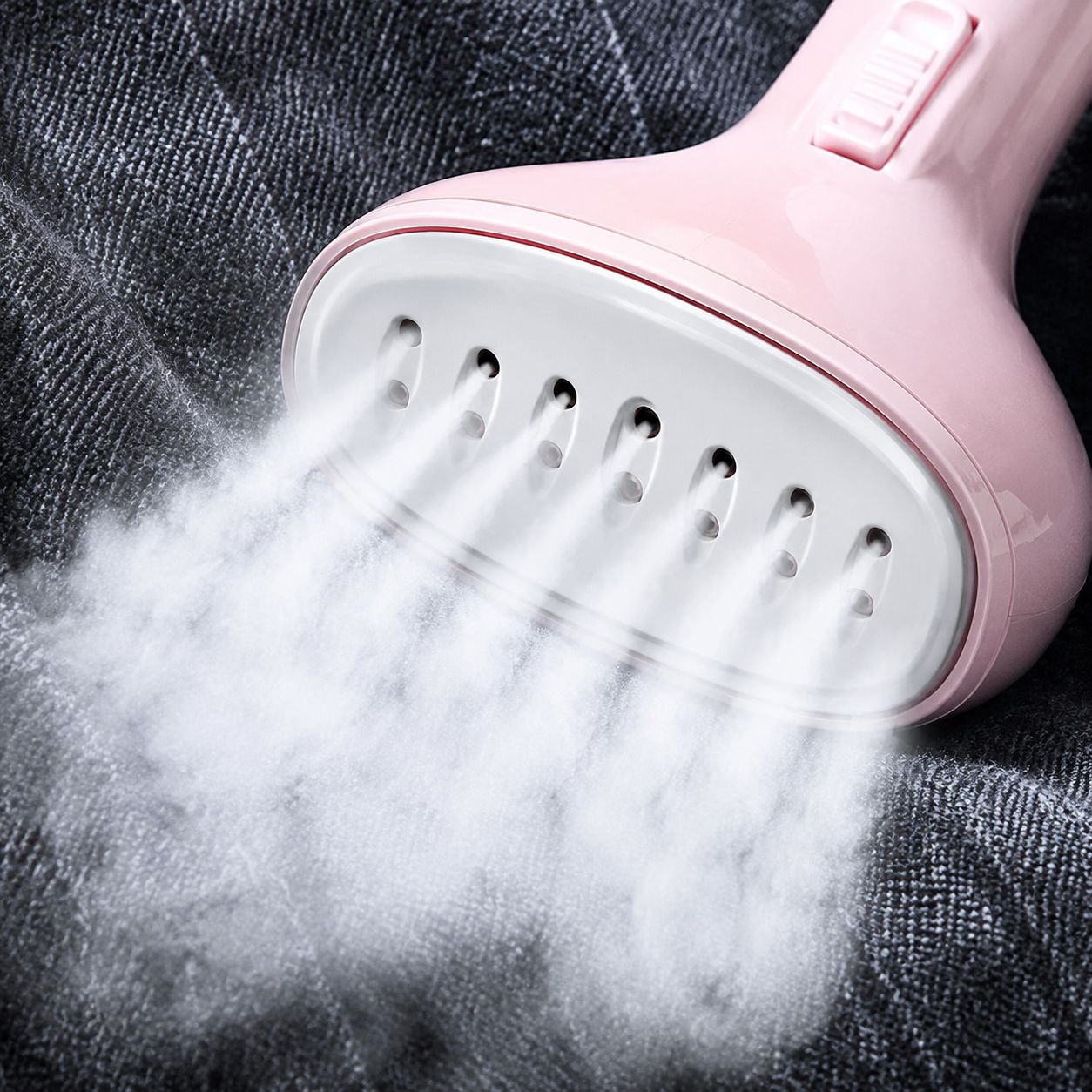 Compact garment steamer in use at home