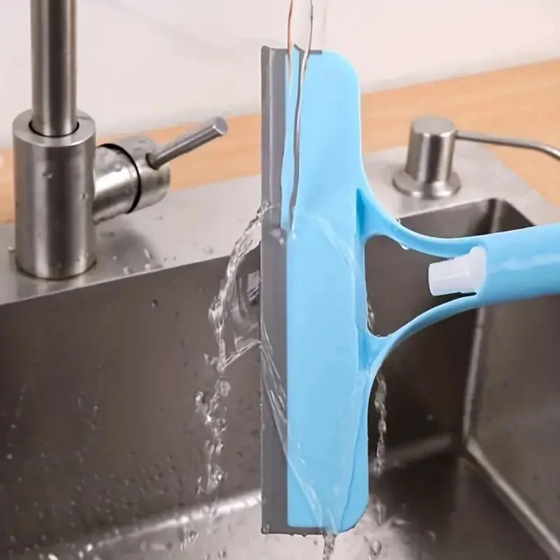 Shower squeegee removing water from glass door